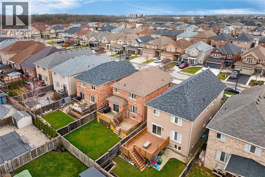 Aerial view of the property and its surrounding neighbourhood, showcasing residential homes with well-maintained lawns and paved streets - 44 Matteo Trail, Hamilton, ON - Outdoor