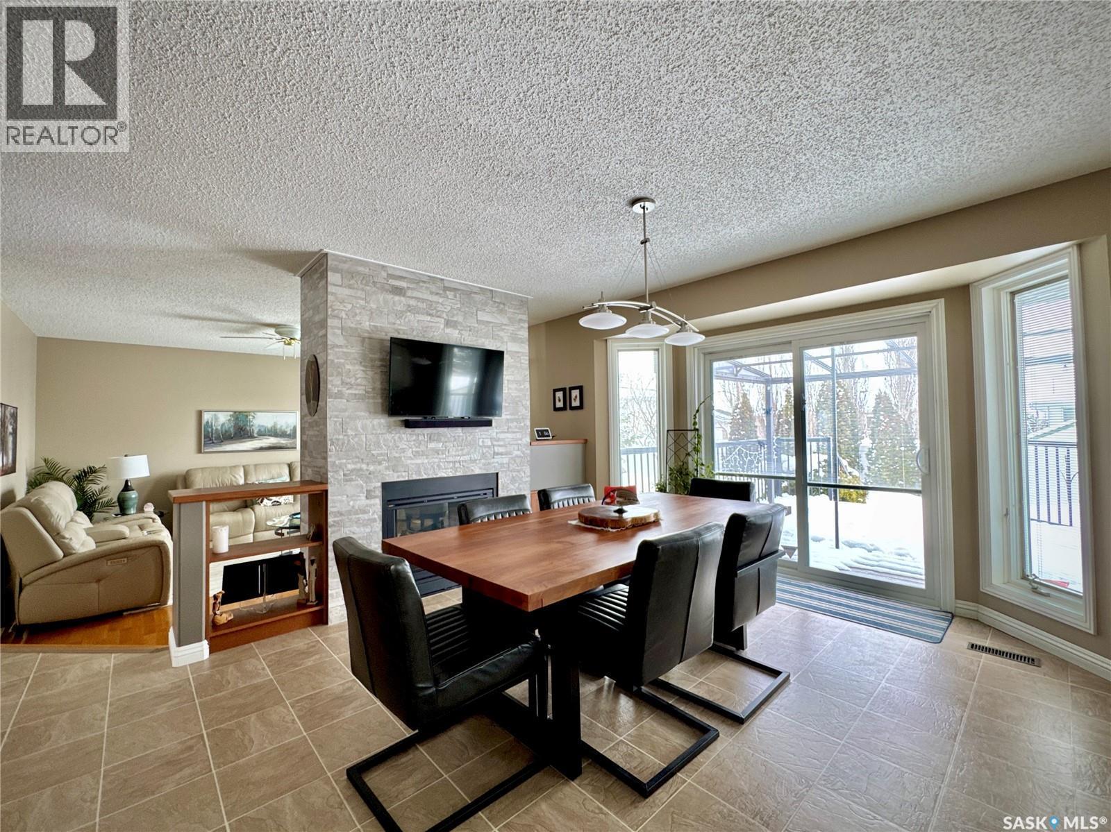140 Morrison Drive, Yorkton, SK - Indoor Photo Showing Dining Room With Fireplace