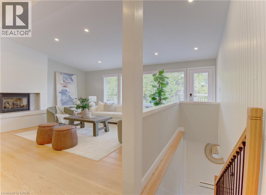 Living area featuring hardwood floors, a fireplace with a hearth, and recessed lighting - 400 Manchester Road, Kitchener, ON - Indoor With Fireplace