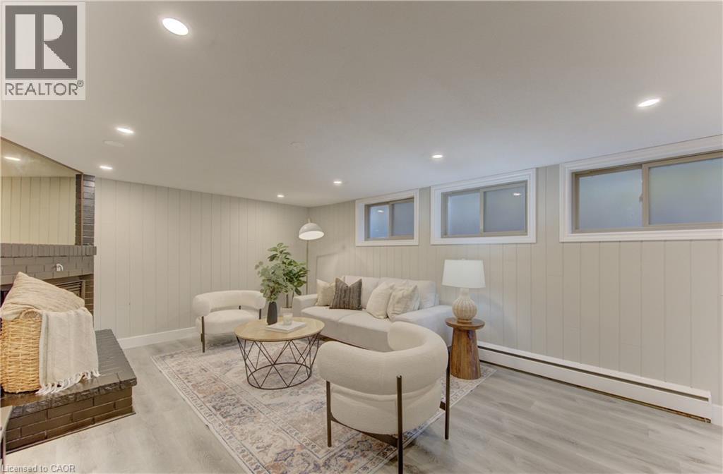 Living area featuring recessed lighting, paneled walls, and flooring with a wood grain finish - 400 Manchester Road, Kitchener, ON - Indoor