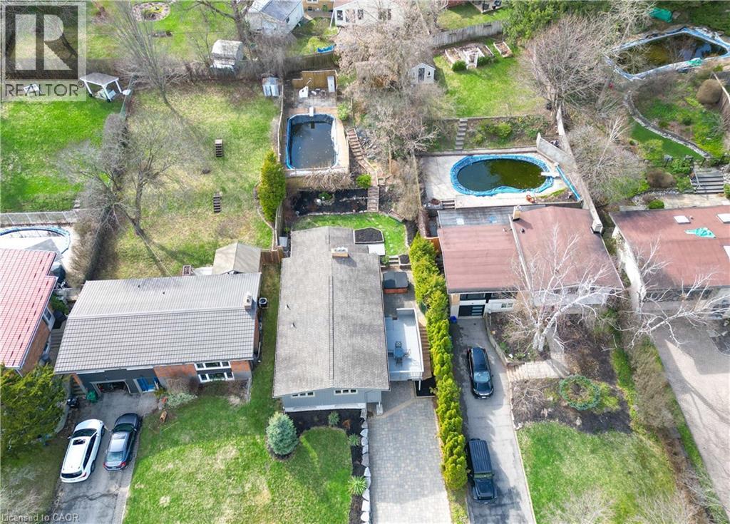 Overhead view of the property, showcasing a paved driveway, a well-maintained lawn, and a grey-roofed residence - 400 Manchester Road, Kitchener, ON - Outdoor With View