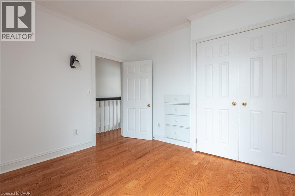 This room features hardwood floors, white walls, and crown molding - 198 Bay Street N, Hamilton, ON - Indoor Photo Showing Other Room