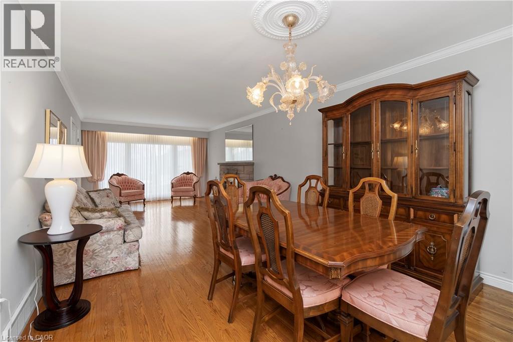 This living space features hardwood floors and a decorative ceiling medallion with an ornate chandelier - 36 Buckingham Drive, Hamilton, ON - Indoor Photo Showing Dining Room
