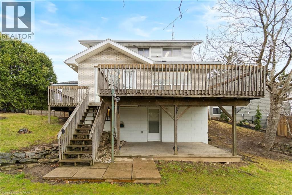 The property features an elevated wooden deck with railings, accessible via a wooden staircase - 36 Buckingham Drive, Hamilton, ON - Outdoor With Deck Patio Veranda