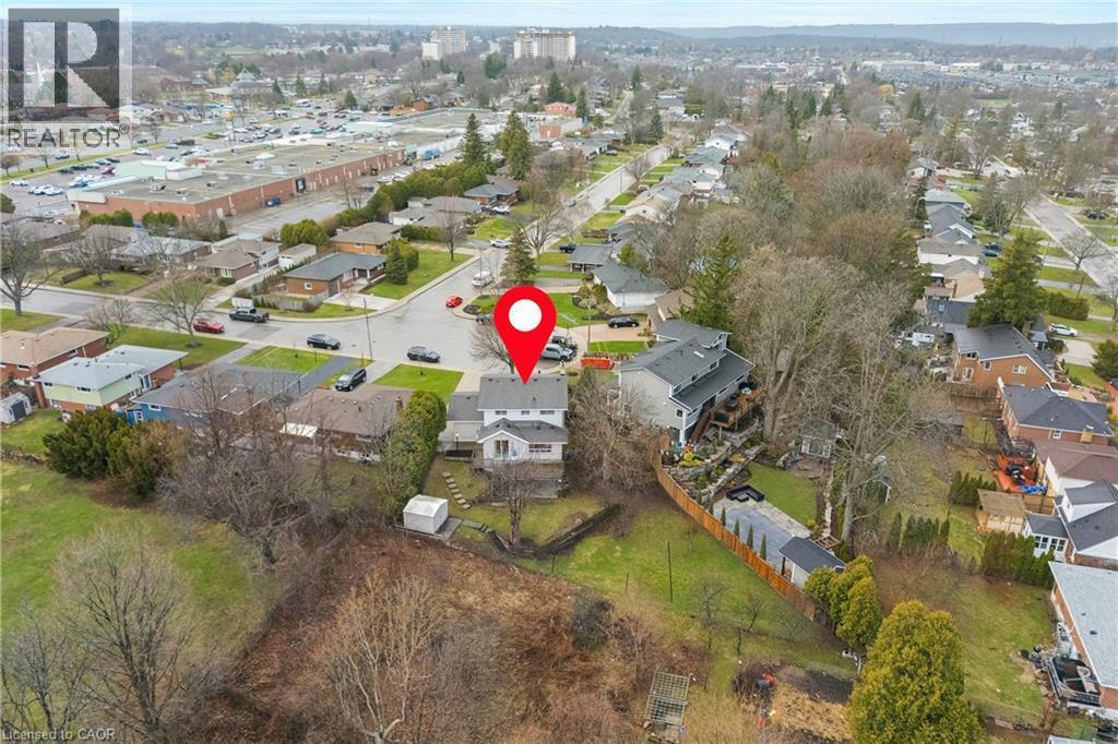 The property is situated on a residential street with surrounding properties featuring various architectural styles and roof colors - 36 Buckingham Drive, Hamilton, ON - Outdoor With View