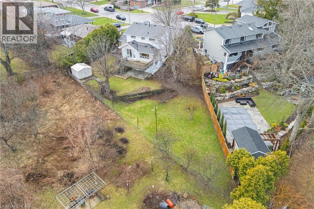 The property features an extensive backyard with a spacious lawn and mature trees, offering ample outdoor space - 36 Buckingham Drive, Hamilton, ON - Outdoor With View