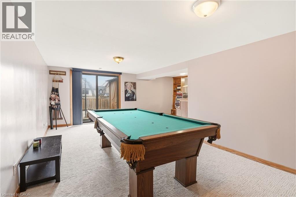 Recreation room featuring a pool table, light-colored carpet, and a glass sliding door providing outdoor access - 2349 Middlesmoor Crescent, Burlington, ON - Indoor Photo Showing Other Room