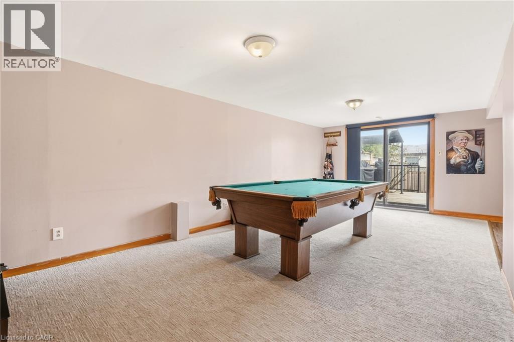 Spacious room featuring carpeting, light-colored walls, and a sliding glass door providing external access - 2349 Middlesmoor Crescent, Burlington, ON - Indoor Photo Showing Other Room