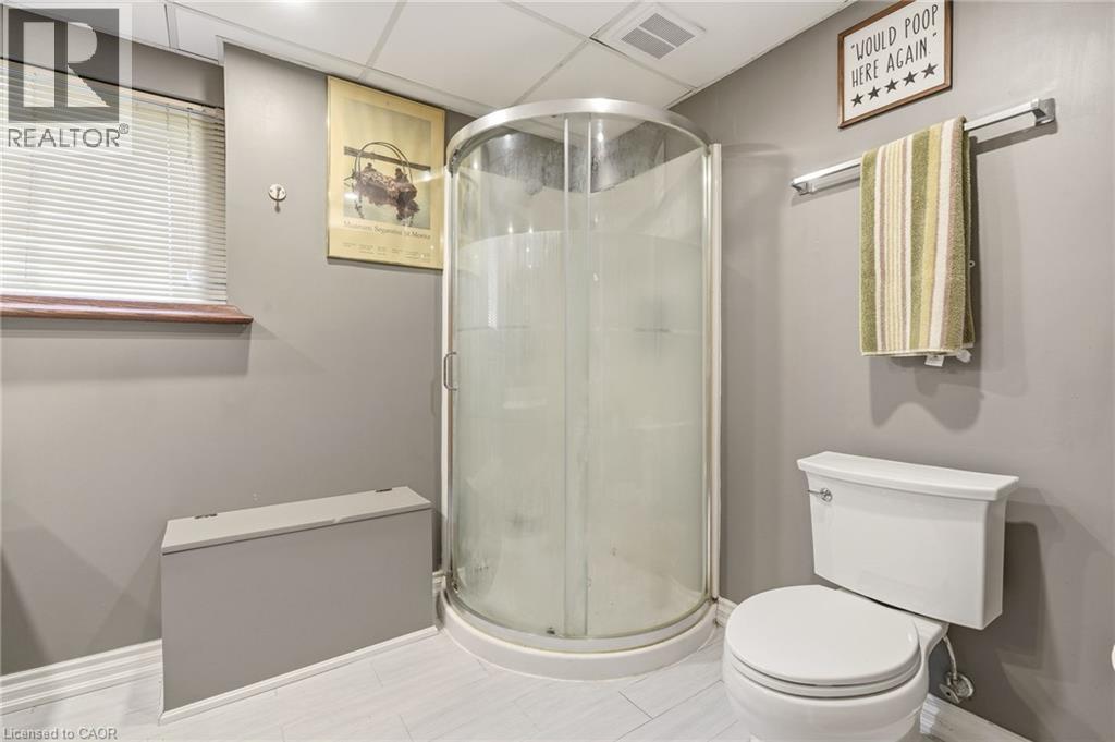 This bathroom features a clear glass corner shower, a toilet, and light-colored flooring - 2349 Middlesmoor Crescent, Burlington, ON - Indoor Photo Showing Bathroom