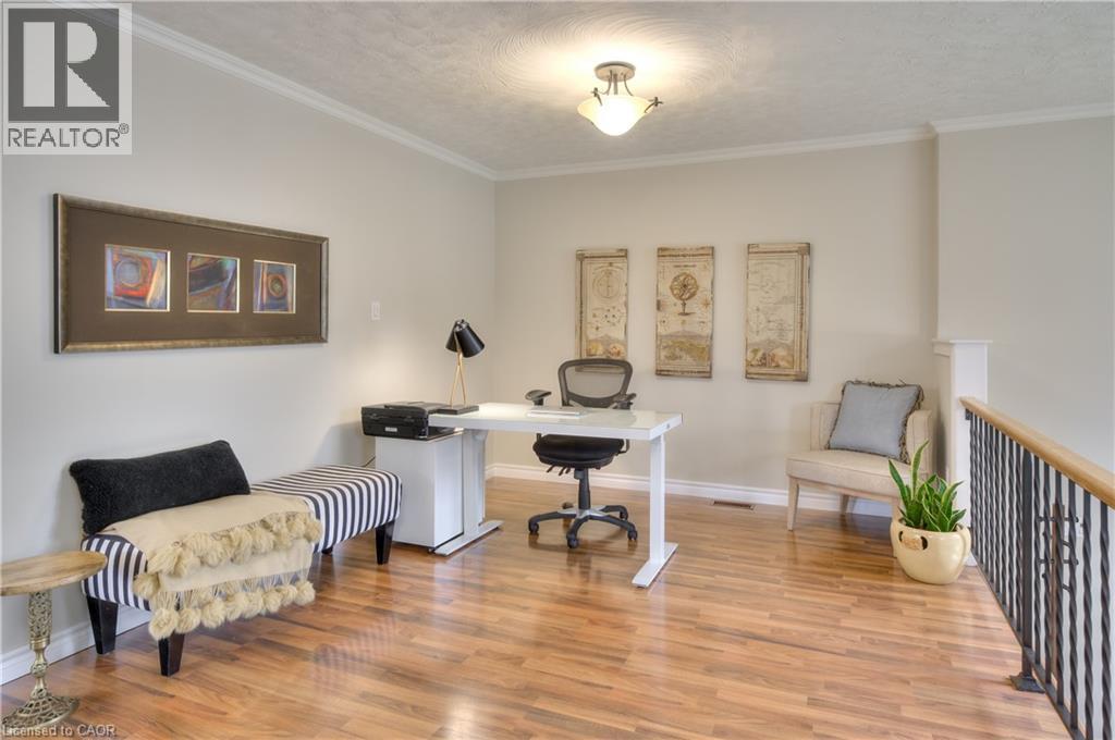 This versatile interior space features hardwood flooring, light-colored walls, and crown molding - 42 Culpepper Drive, Waterloo, ON - Indoor Photo Showing Office