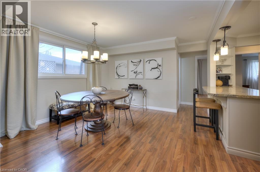 The property features hardwood floors, a chandelier, and crown molding - 42 Culpepper Drive, Waterloo, ON - Indoor Photo Showing Dining Room