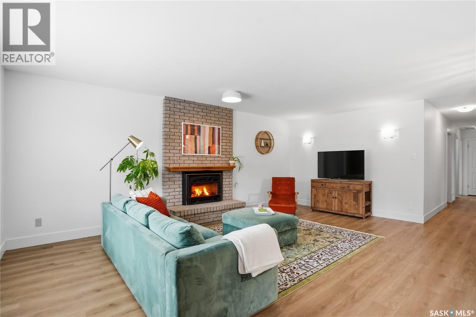 418 Pinehouse Drive, Saskatoon, SK - Indoor Photo Showing Living Room With Fireplace