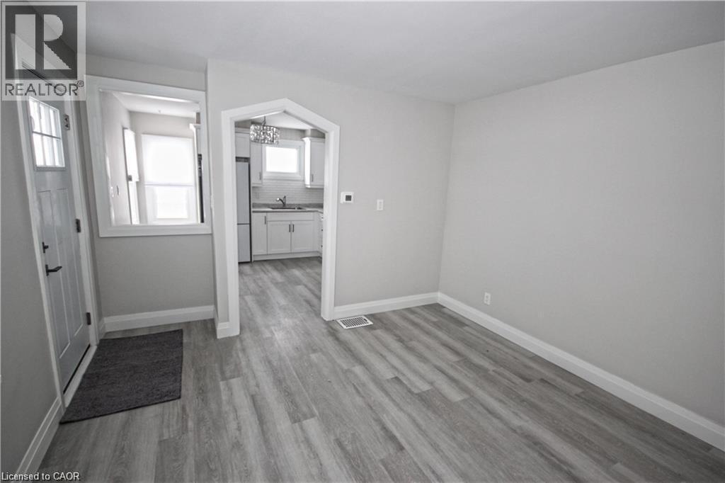 The property features light gray walls and wood-look flooring - 1356 Upper Wellington Street, Hamilton, ON - Indoor Photo Showing Other Room