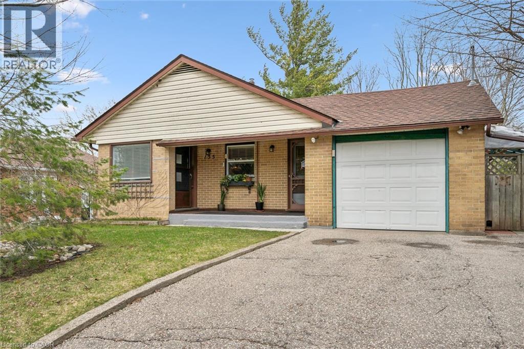 The property features a brick exterior with a front-facing garage, a paved driveway, and a well-maintained lawn - 155 Hungerford Road, Cambridge, ON - Outdoor