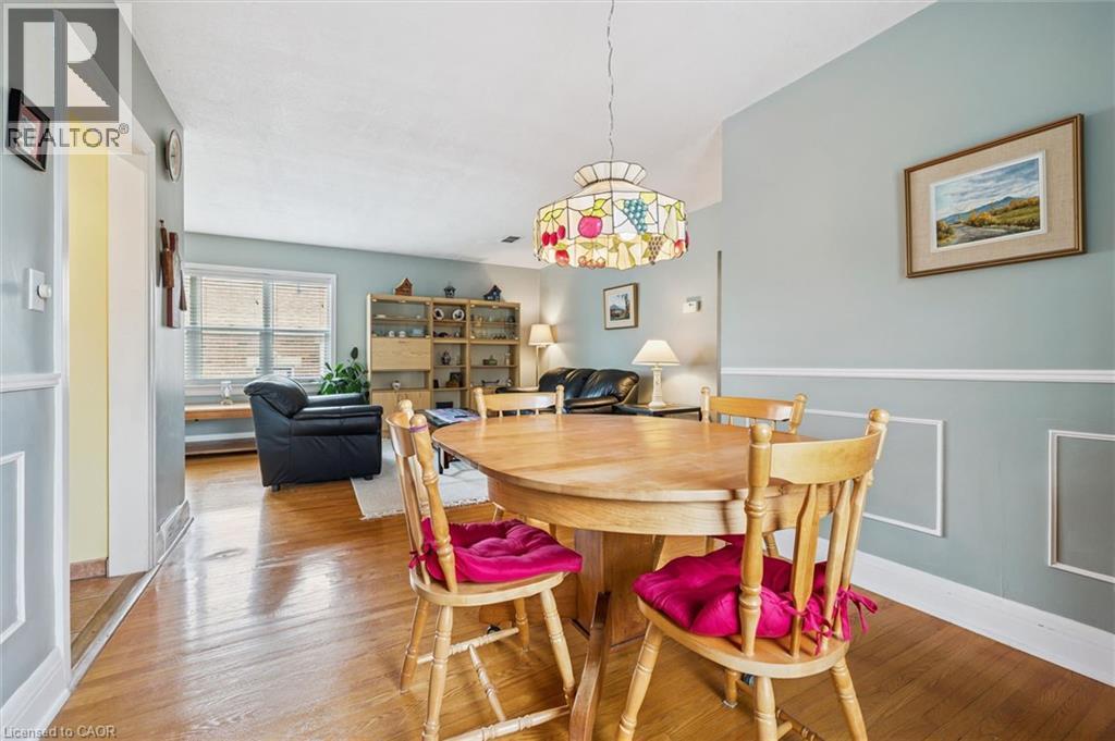 Dining area with hardwood floors and a decorative ceiling light fixture - 155 Hungerford Road, Cambridge, ON - Indoor Photo Showing Dining Room