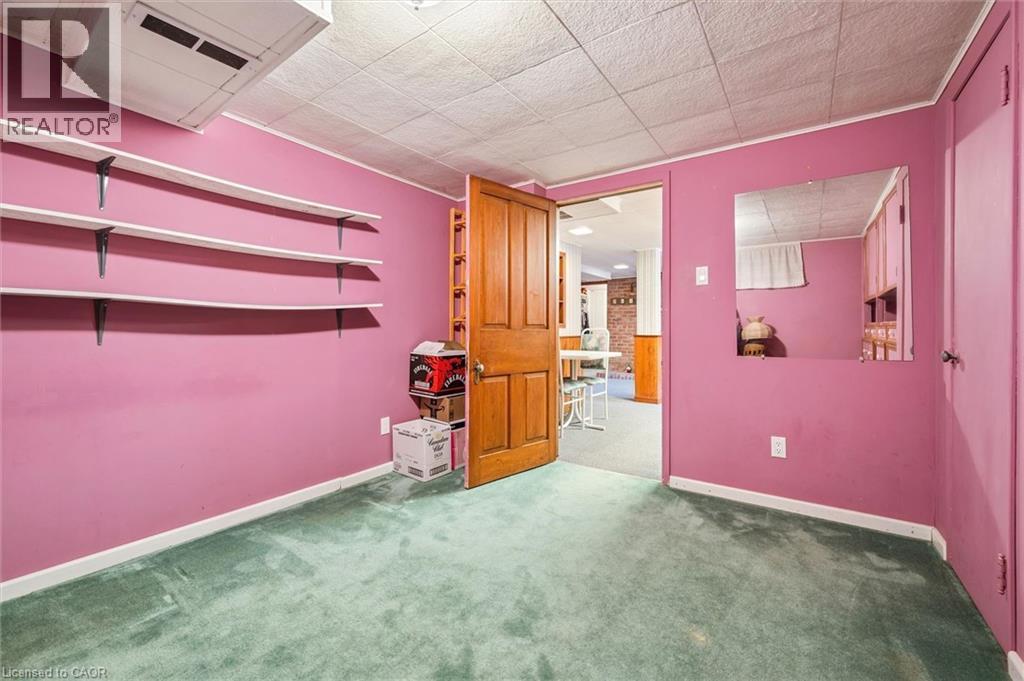 This room features pink walls, green carpet, and a white ceiling with recessed lighting - 155 Hungerford Road, Cambridge, ON - Indoor Photo Showing Other Room