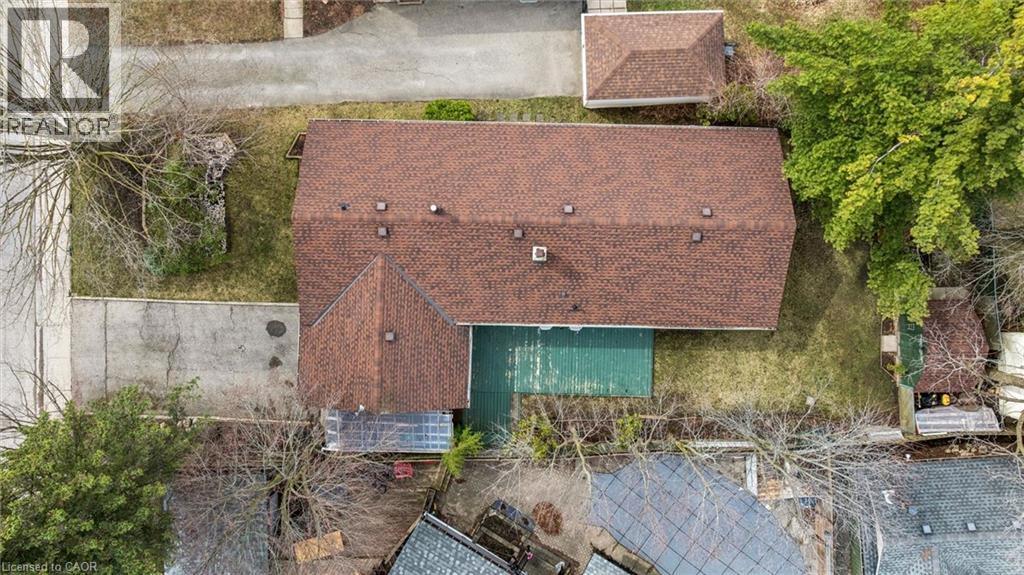 Overhead view of the property, showcasing a prominent brown shingle roof, a green deck, and a detached structure with a matching brown shingle roof - 155 Hungerford Road, Cambridge, ON - Outdoor