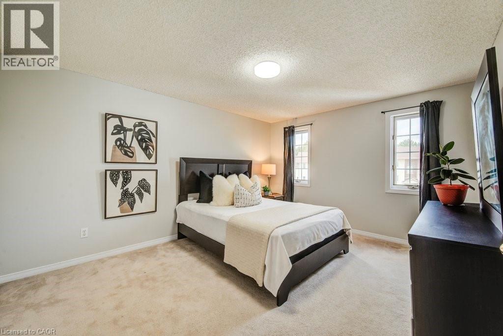 Bedroom with light colored carpet and a textured ceiling - 633 Grange Crescent, Waterloo, ON - Indoor Photo Showing Bedroom