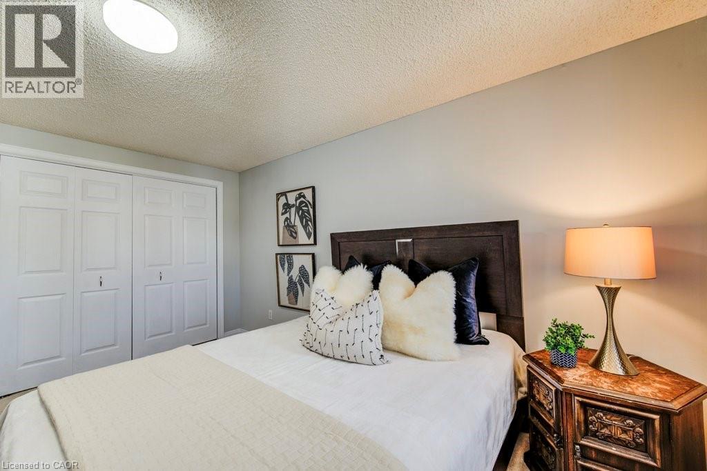 Bedroom with a textured ceiling and a closet - 633 Grange Crescent, Waterloo, ON - Indoor Photo Showing Bedroom