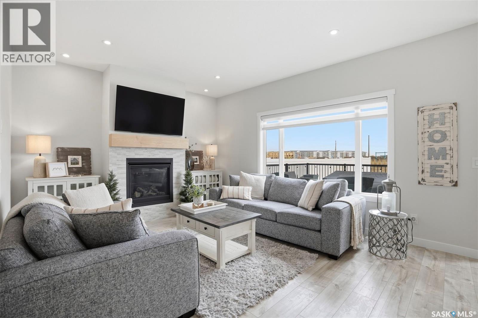 342 Stilling Manor, Saskatoon, SK - Indoor Photo Showing Living Room With Fireplace