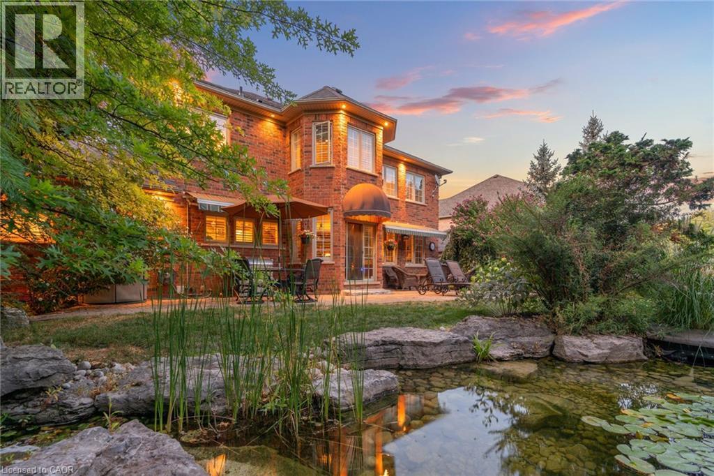 The property features a brick exterior with multiple windows and an outdoor patio space - 4278 Clubview Drive, Burlington, ON - Outdoor With Deck Patio Veranda
