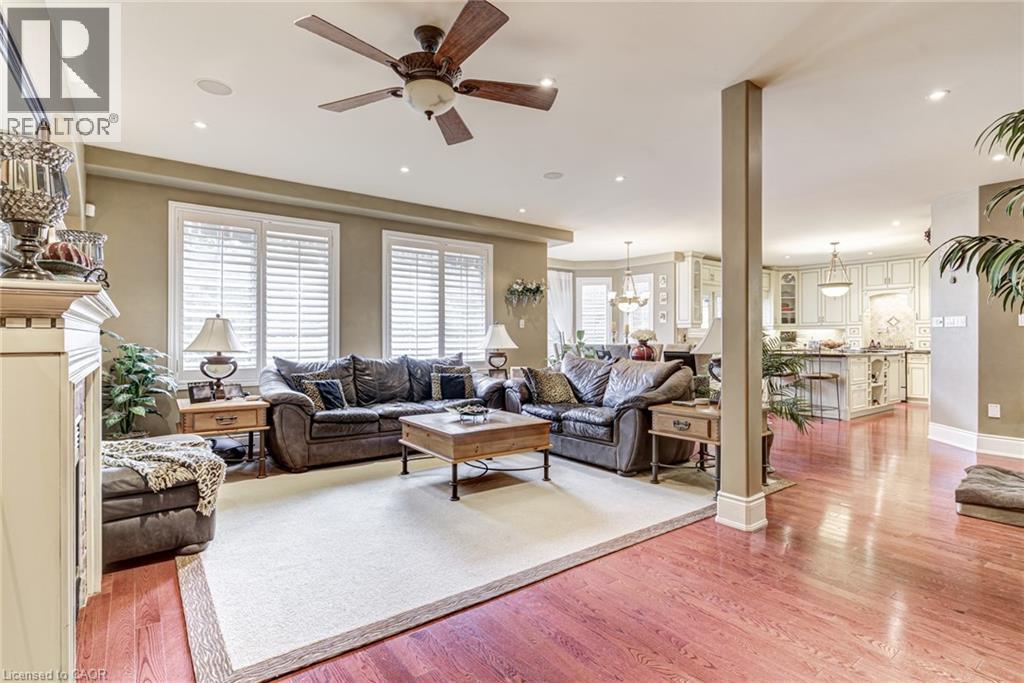 Spacious living area featuring hardwood flooring, a ceiling fan, and recessed lighting - 4278 Clubview Drive, Burlington, ON - Indoor Photo Showing Living Room With Fireplace