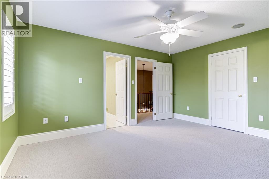 This room features carpeted flooring, a ceiling fan, and window shutters - 4278 Clubview Drive, Burlington, ON - Indoor