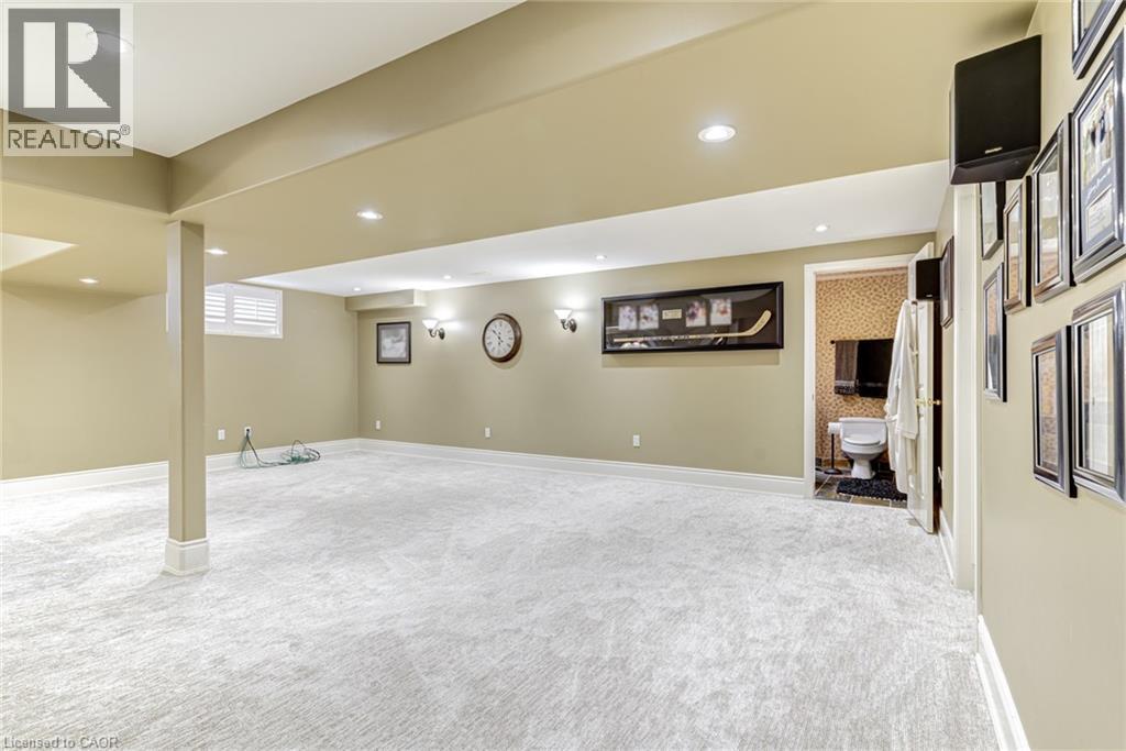 Expansive carpeted area with recessed lighting, an accessible lavatory, and a window with blinds - 4278 Clubview Drive, Burlington, ON - Indoor