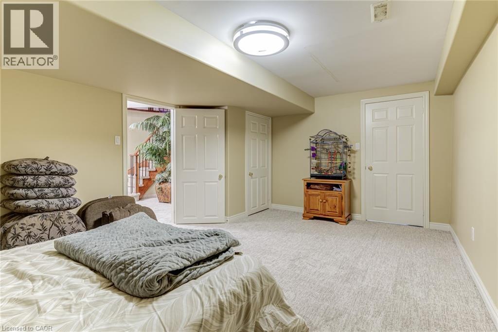The property features a versatile area with light-colored carpeting and neutral-toned walls - 4278 Clubview Drive, Burlington, ON - Indoor Photo Showing Bedroom