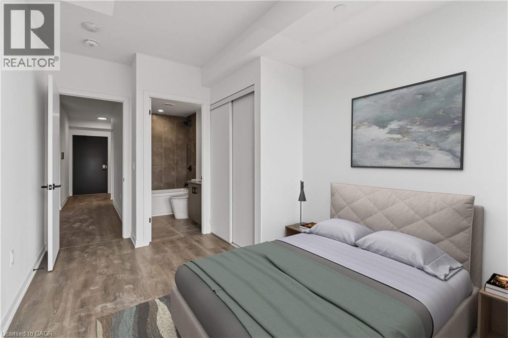 This property features light-colored walls, wood-style flooring, and a modern bathroom with a tiled shower - 4878 Powers Common Unit# 224, Burlington, ON - Indoor Photo Showing Bedroom