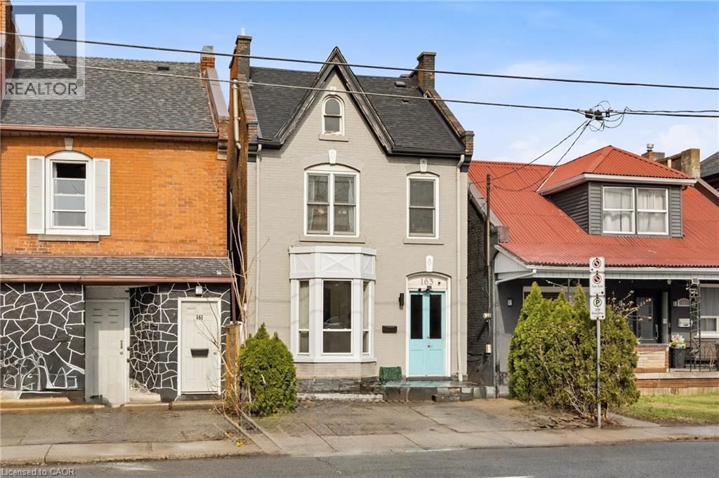 View of front of house with a chimney, roof with shingles, and brick siding - 163 Victoria Avenue N, Hamilton, ON - Outdoor With Facade