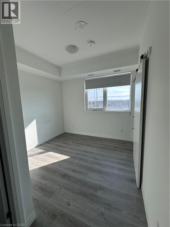 Room featuring a window with a roller blind, and light-toned flooring - 108 Garment Street S Unit# 708, Kitchener, ON - Indoor Photo Showing Other Room