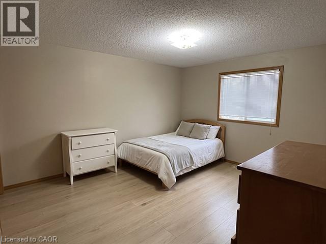 Neutral wall tones with wood-finish flooring - 70 Bechtel Drive, Kitchener, ON - Indoor Photo Showing Bedroom