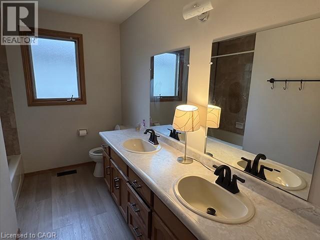 Double vanity with integrated sinks and matte black fixtures, set on a patterned countertop - 70 Bechtel Drive, Kitchener, ON - Indoor Photo Showing Bathroom