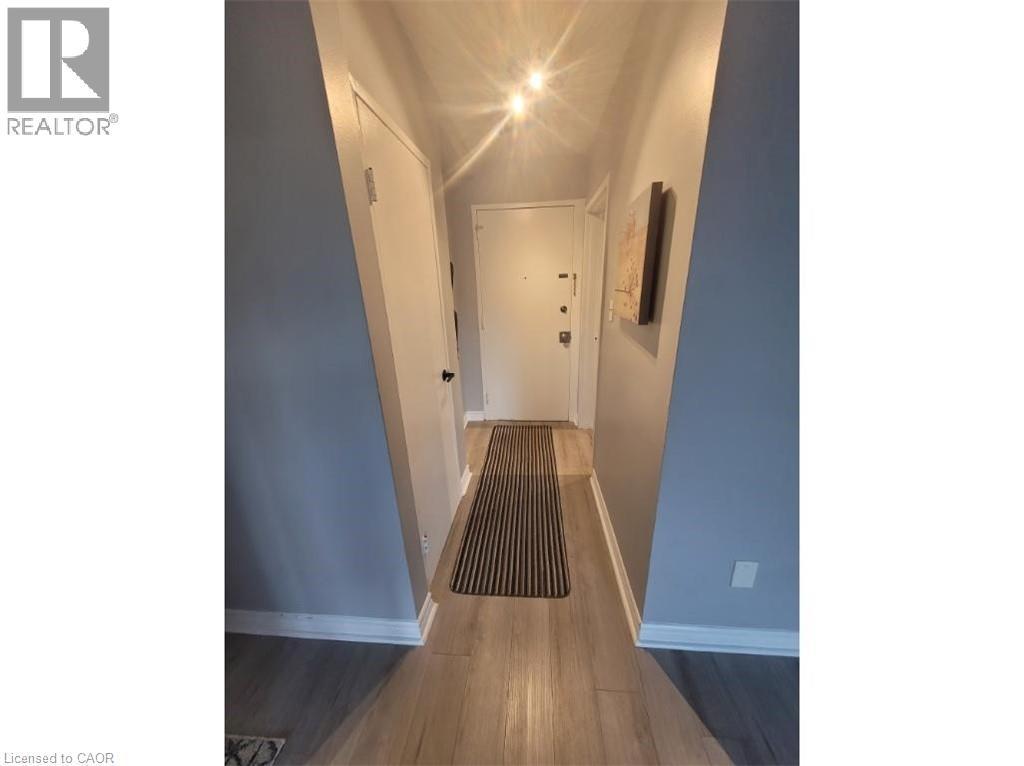 Inviting entryway featuring light-colored flooring, light blue walls, and bright overhead lighting - 981 Mohawk Road E, Hamilton, ON - Indoor Photo Showing Other Room