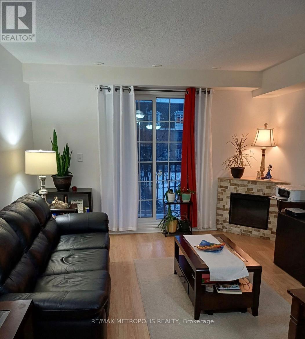 12 - 45 Cedarcroft Boulevard, Toronto, ON - Indoor Photo Showing Living Room With Fireplace