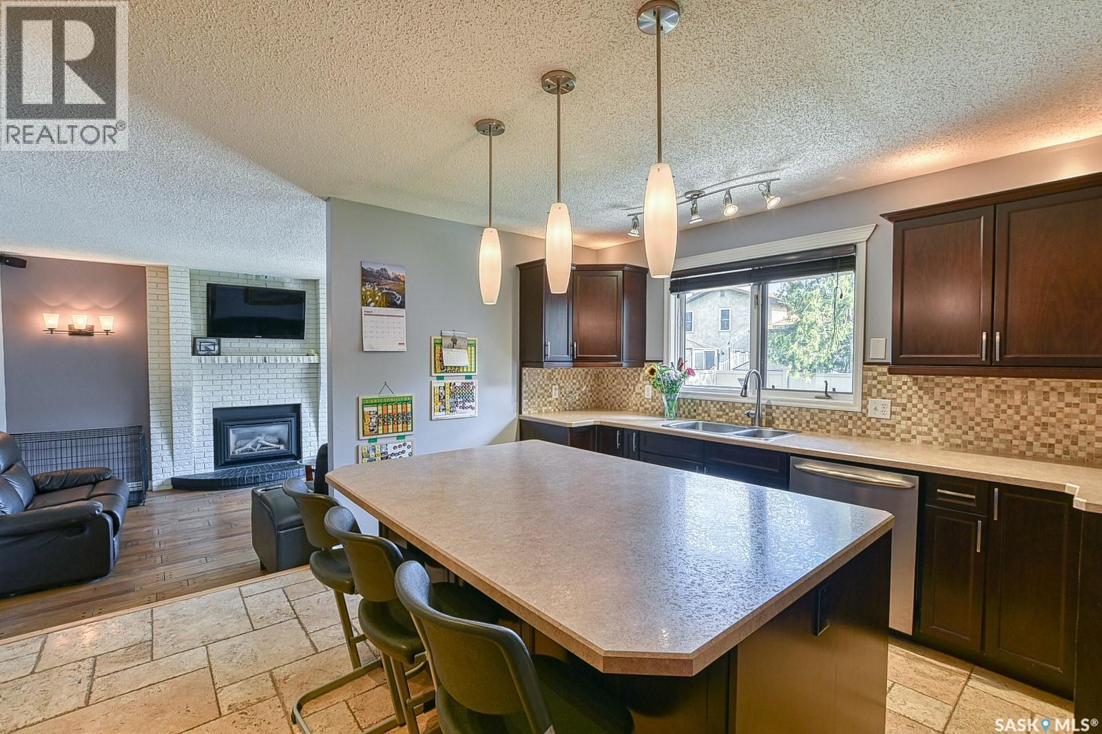 2102 Truesdale Drive E, Regina, SK - Indoor Photo Showing Kitchen With Fireplace With Double Sink