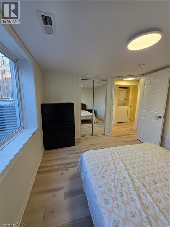 Light-filled room featuring light-toned flooring, a window providing natural light, and a ceiling light fixture - 62 Richwill Road Unit# Lower, Hamilton, ON - Indoor Photo Showing Bedroom