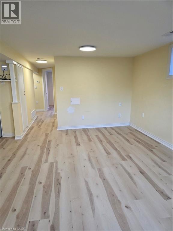 This room features light-colored walls and light wood flooring, illuminated by overhead lighting fixtures - 62 Richwill Road Unit# Lower, Hamilton, ON - Indoor Photo Showing Other Room
