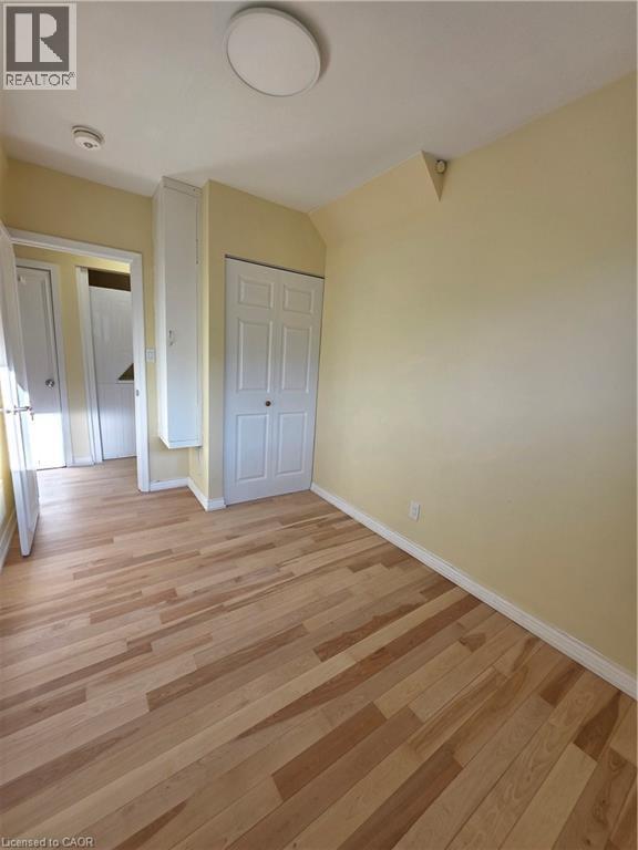 This room features light-colored walls, light wood flooring, and white trim - 62 Richwill Road Unit# Upper, Hamilton, ON - Indoor Photo Showing Other Room