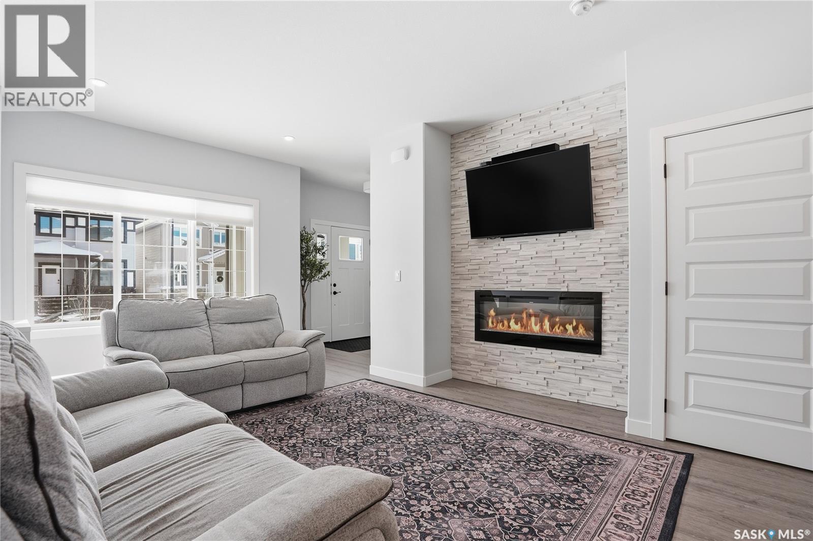 1047 Brighton Gate, Saskatoon, SK - Indoor Photo Showing Living Room With Fireplace