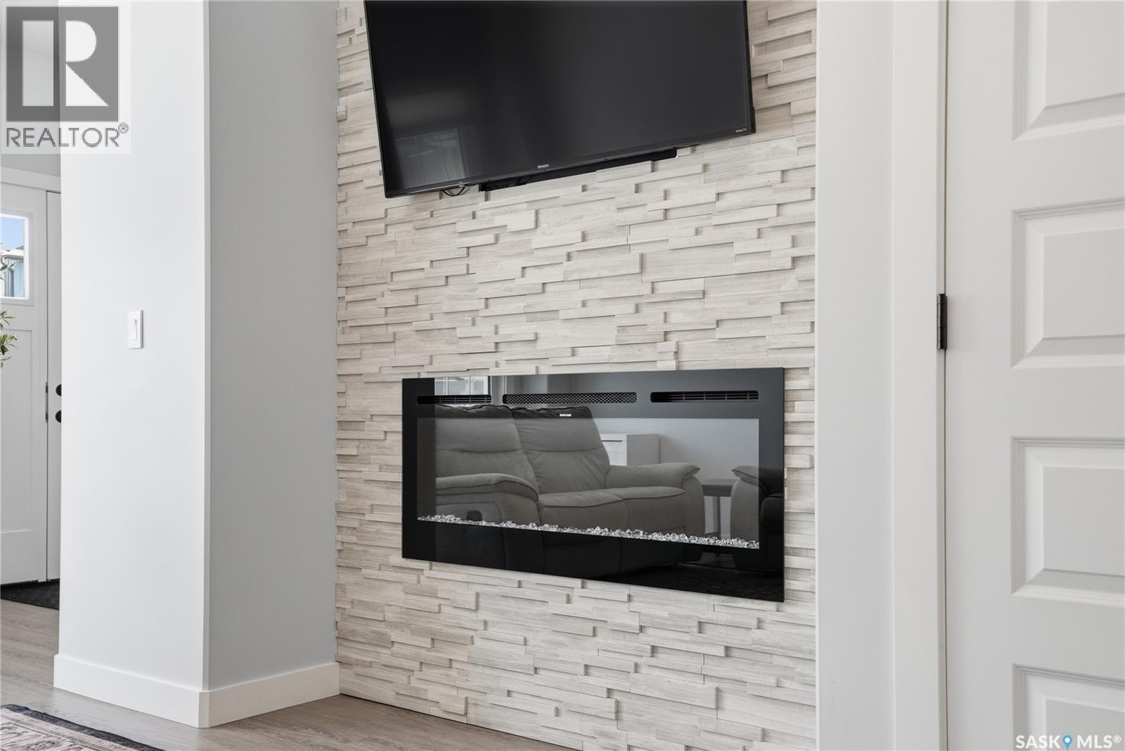 1047 Brighton Gate, Saskatoon, SK - Indoor Photo Showing Other Room With Fireplace