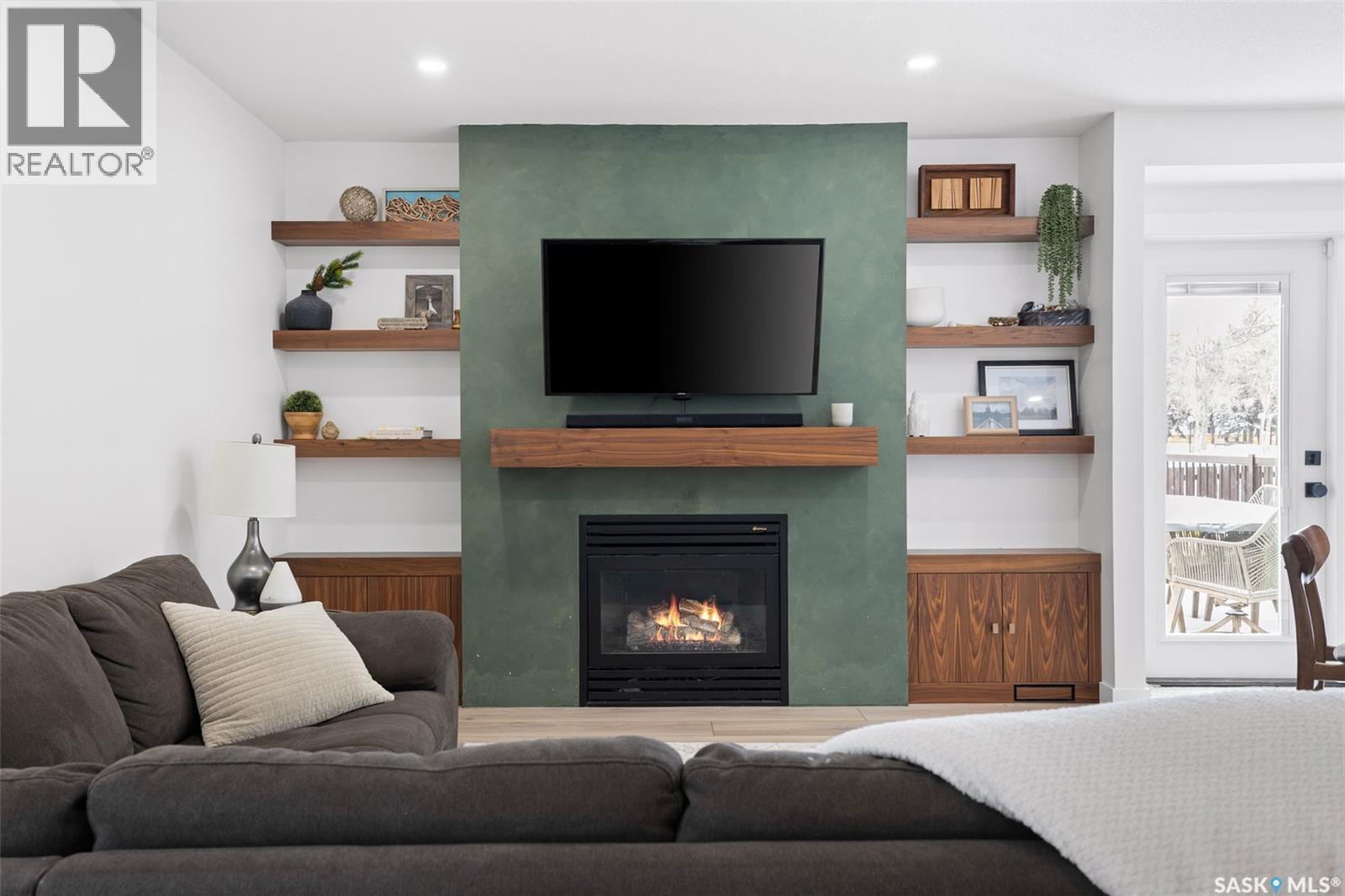 2002 Braun Bay E, Regina, SK - Indoor Photo Showing Living Room With Fireplace