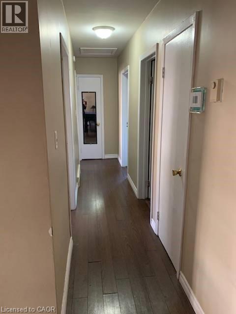 Corridor with baseboards and dark wood-style floors - 65 Cardill Crescent Unit# A, Waterloo, ON - Indoor Photo Showing Other Room