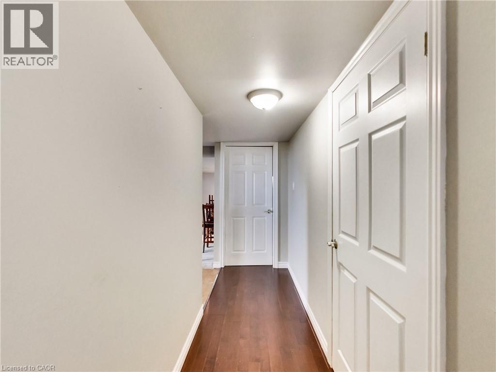 Hallway featuring wood-finish flooring and light-toned walls - 9183 Silver Street, Caistor Centre, ON - Indoor Photo Showing Other Room