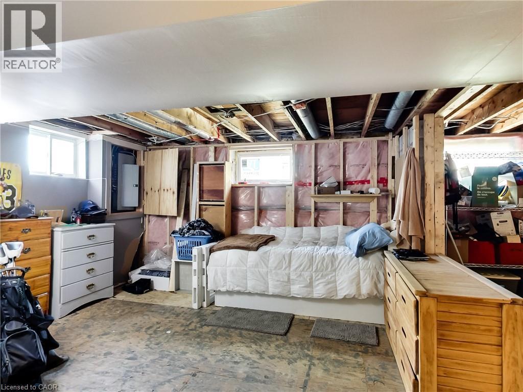 Unfinished space featuring exposed ceiling joists and framing, a concrete floor, and multiple windows - 9183 Silver Street, Caistor Centre, ON - Indoor