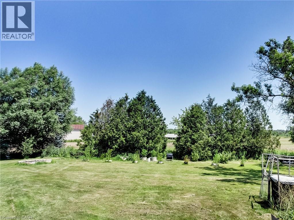 Expansive outdoor space featuring a manicured lawn, mature trees, and landscaping elements - 9183 Silver Street, Caistor Centre, ON - Outdoor