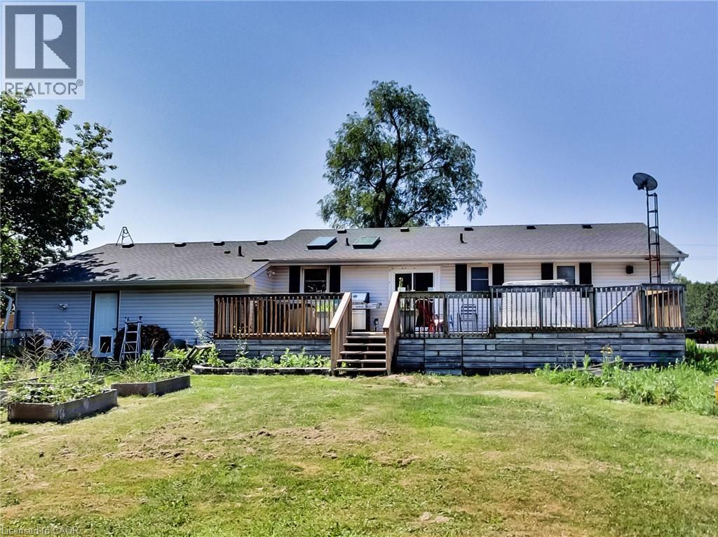 Expansive rear deck featuring wood railings and stairs, providing outdoor recreation space - 9183 Silver Street, Caistor Centre, ON - Outdoor With Deck Patio Veranda