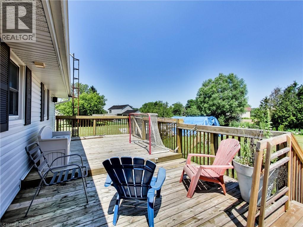 Expansive wood deck with full railing system, offering exterior access and outdoor living space - 9183 Silver Street, Caistor Centre, ON - Outdoor With Deck Patio Veranda With Exterior