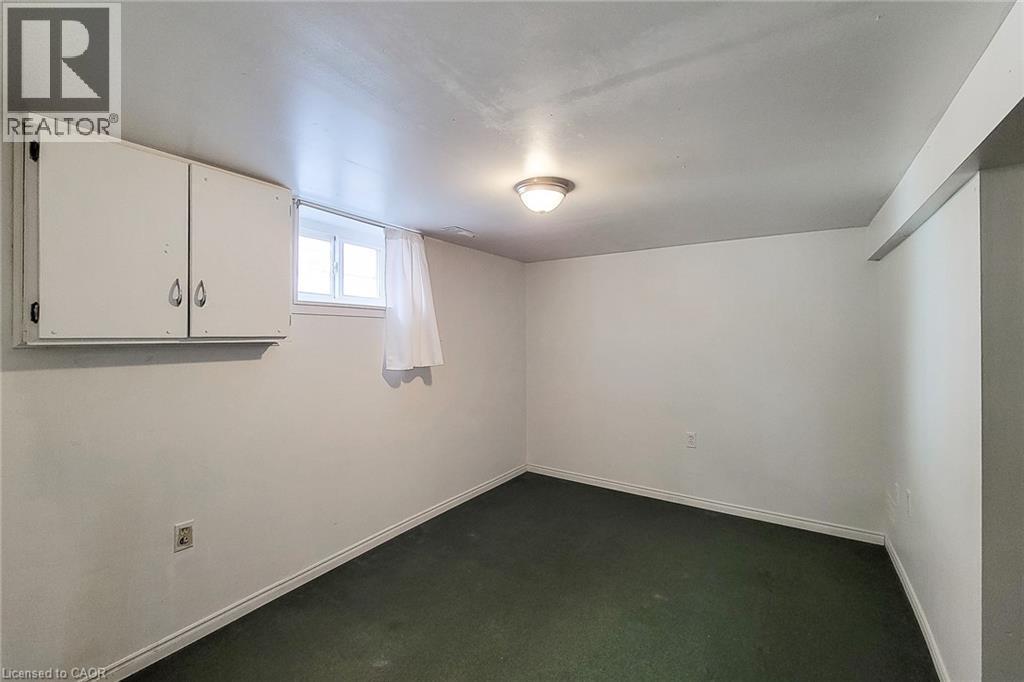 Finished room with green carpeting, white walls, and a ceiling-mounted light fixture - 66 Cline Avenue Unit# Main Floor, Hamilton, ON - Indoor Photo Showing Other Room